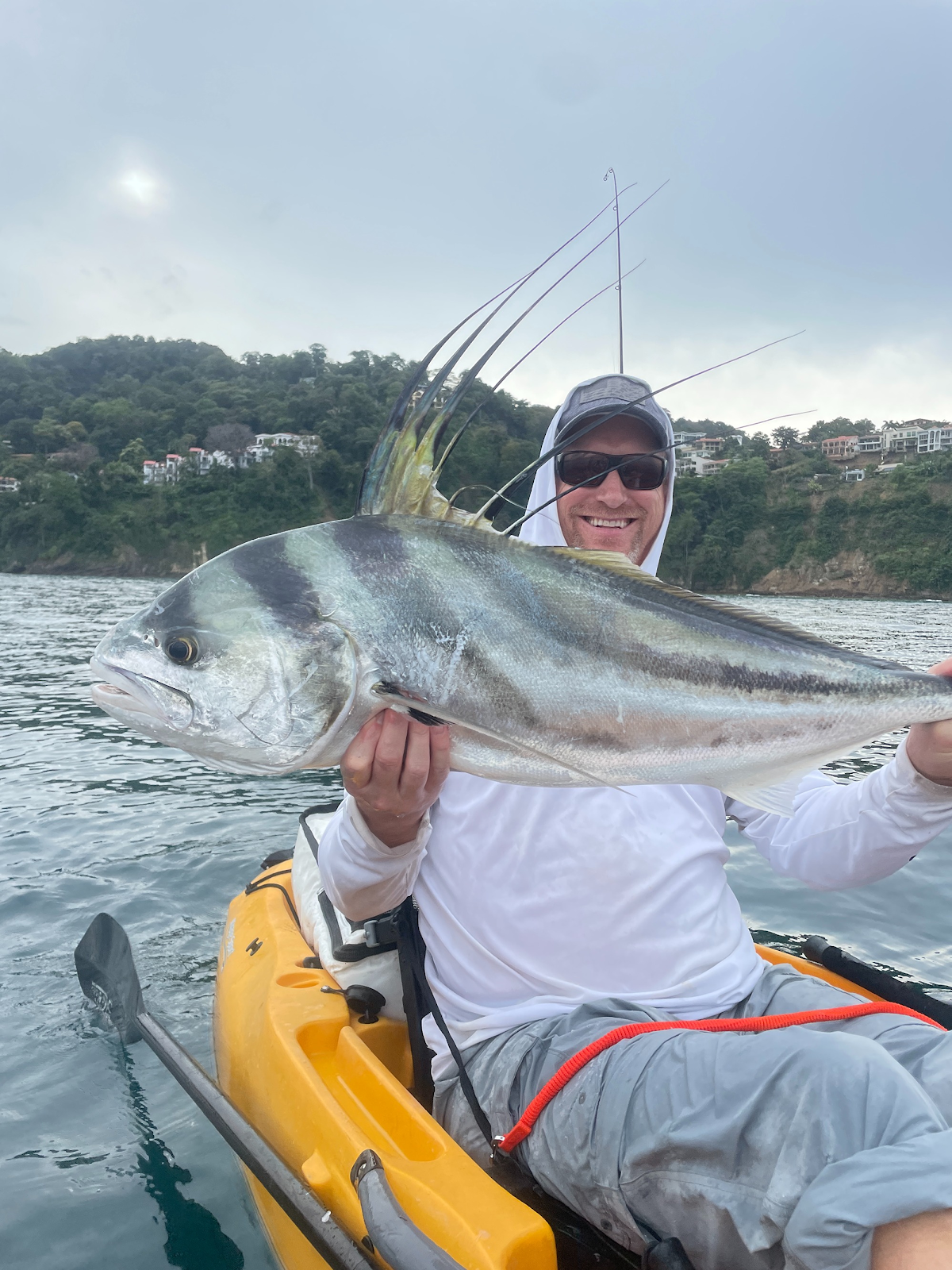 Angler with a roosterfish on a kayak